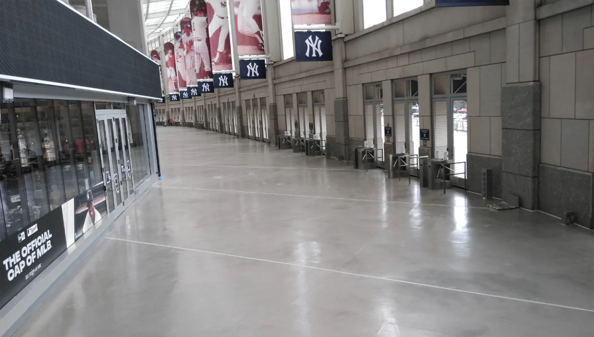 A long hallway in a building adorned with numerous banners showcasing diverse flooring systems and solutions.