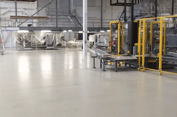 A large warehouse with advanced flooring systems and solutions, housing a multitude of equipment.