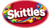 Skittles logo featuring the brand name in white letters on a red oval background with colorful candy pieces and a rainbow swirl.