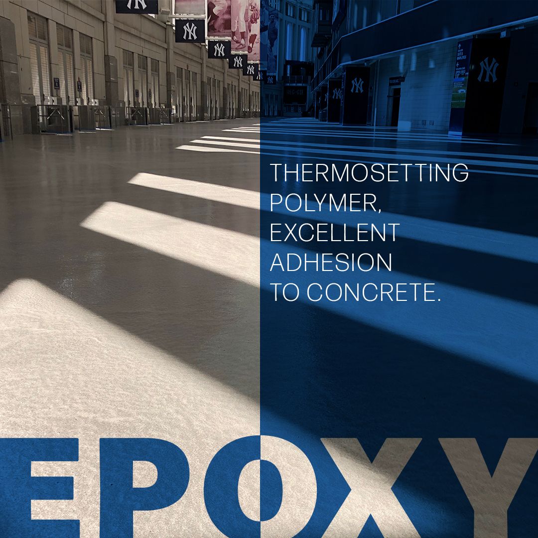 A smooth, reflective epoxy-coated floor in a building corridor highlights the benefits of thermosetting polymers with excellent adhesion to concrete, showcasing the differences between resin flooring vs epoxy flooring for modern surfaces.