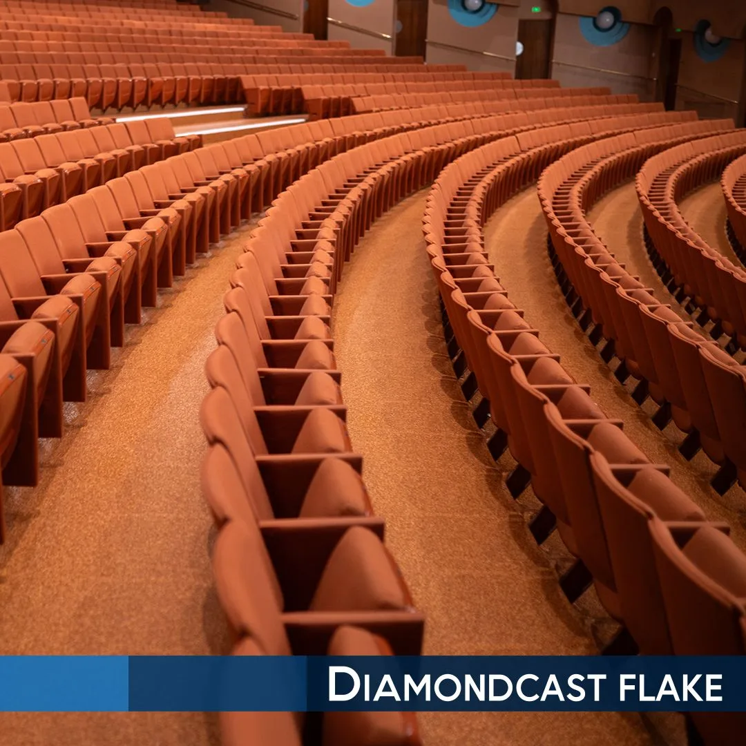 Rows of empty brown seats in a large auditorium with curved aisles; text overlay reads "Diamondcast flake.