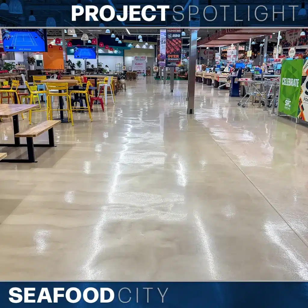 Interior of a Seafood City grocery store with a dining area featuring yellow and red chairs, polished concrete floors, and checkout lanes in the background.